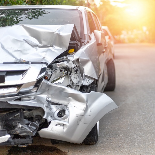 Silver car after accident with front fender damaged